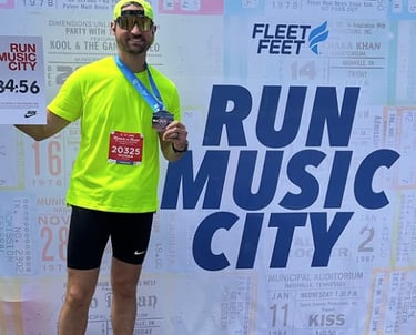 a photo of the owner of Race Ready events standing in front of a wall for the Nashville Marathon