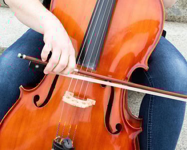 Cello instructor showing bow technique on cello