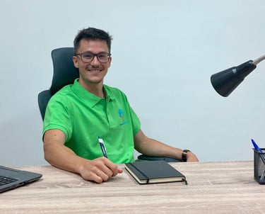 a man sitting at a desk with a laptop and a laptop