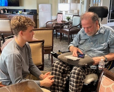 Teens Who Tech helping an elderly man feel more comfortable with technology