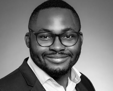 a man in a suit and glasses smiling
