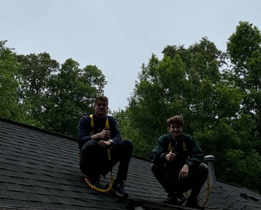two men sitting on a roof top