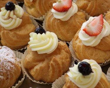 a variety of pastries on display in a bakery