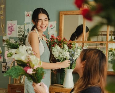 a woman is smiling and holding a bouquet