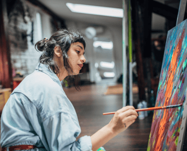 A female artist working on a painting