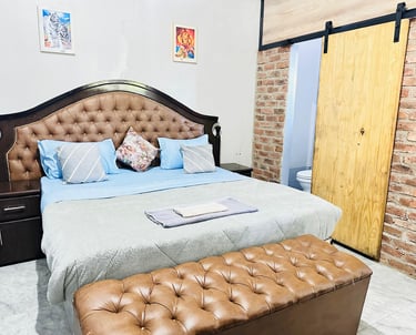King size bed in one of our cozy Tabona House lodge rooms