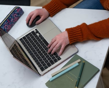 Wirral Brand designer working on brand identity project using MacBook