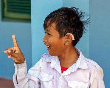 a young boy with hearing aid on his left ear