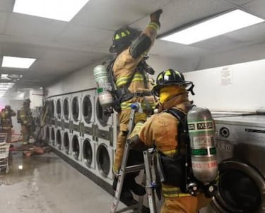 a firefighter is cleaning up after a clothes dryer fire