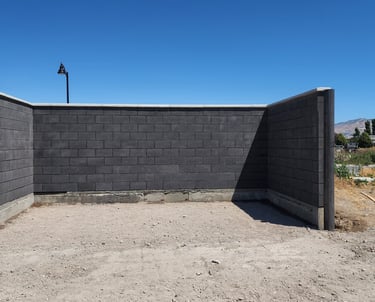 Charcoal colored CMU trash enclosure with precast concrete cap