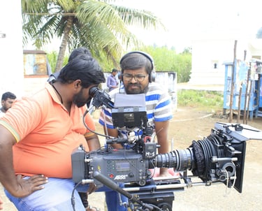 Director and camera man reviewing footage on a corporate film set.