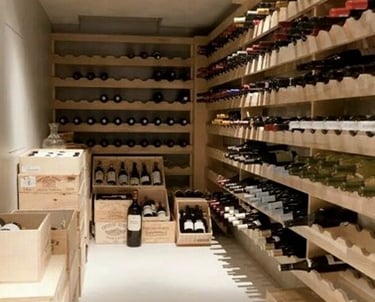 Custom wooden wine cellar storage with wall-mounted racks and crates for organized bottle collection.