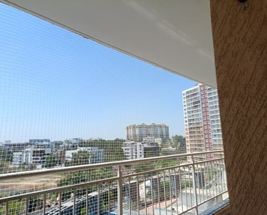 Close-up of tough, weather-resistant pigeon netting neatly installed on a window.