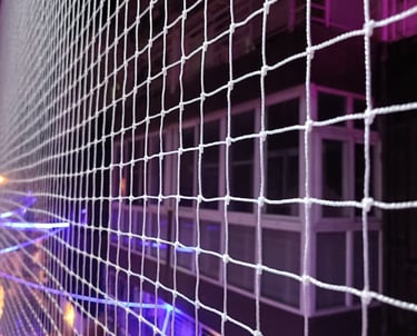 Close-up of a securely installed pigeon safety net on a residential balcony in Bengaluru.