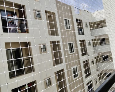 Technician installing a safety net on a high-rise balcony in Bengaluru.