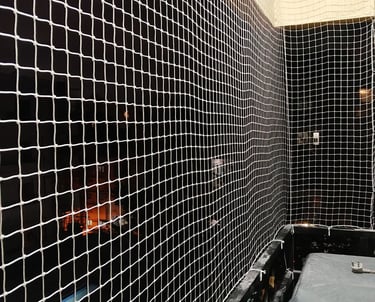 Close-up of durable pigeon safety netting installed on a residential balcony in KR Puram.