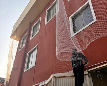 Close-up of sturdy pigeon netting installed on a balcony in Jalahalli.