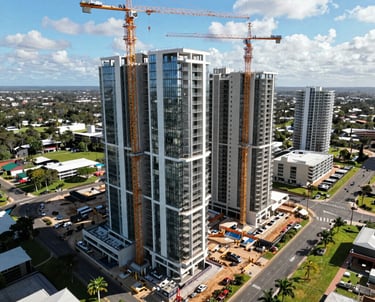 Aerial view of a Queensland property development site with cranes and construction in progress.