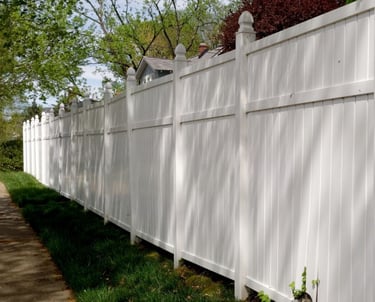 a white fenced in fenced in area with trees
