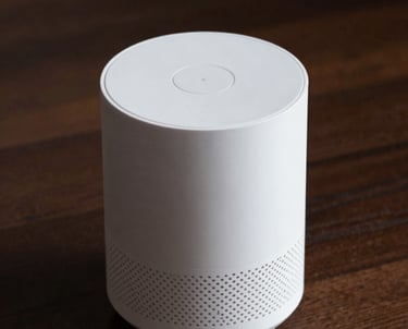 A clean, high-angle shot of a white smart home device on a dark wood surface. Soft, professional lighting.