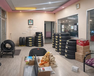 <img src="tyre-sales.jpg" alt="Tyre shop interior with stacked CEAT tyres for cars and bikes">