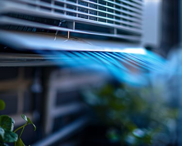 A wall-mounted air conditioner unit blowing cool blue air for energy-efficient indoor climate control.
