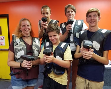 family posing for laser tag