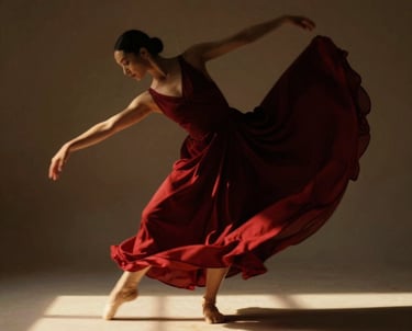 Una elegante bailarina de ballet, con un vestido rojo vaporoso, adopta una pose en puntas en un estu