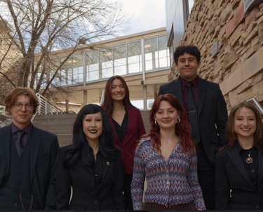 Image of Quesada-Stoner Gregg team standing on a stairwell outdoor by each other.
