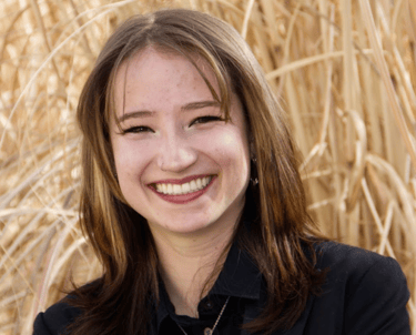 Headshot of Haven Bohn in a black suit.