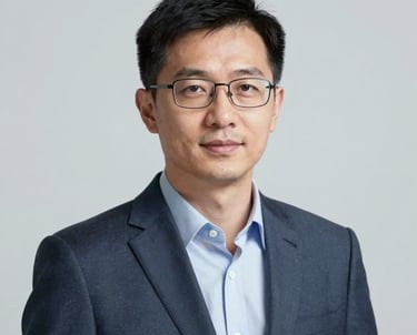 A professional portrait of a man with glasses, looking approachable and knowledgeable. Clean studio lighting with a neutral palette featuring #3C5A6C accents. He represents an expert in academic content.