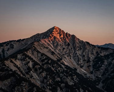 A wide lens shot of a North American mountain peak at twilight, cinematic moody colors.
