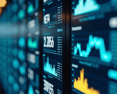 Digital stock market dashboard displaying real-time financial data charts and trading analytics on blue screens.