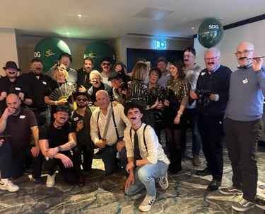 a group of corporate people enjoy a murder mystery party