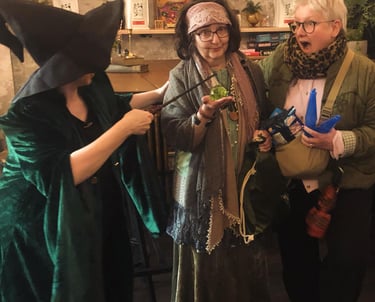 three women at a Harry Potter themed quiz. one looks shocked.