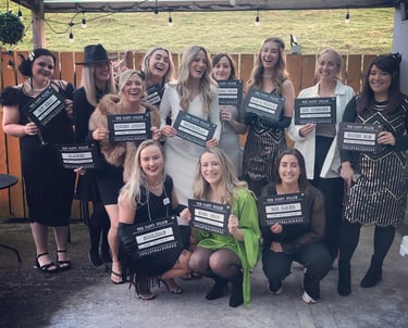 a group of girls at a1920s murder mystery party.