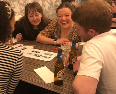 Girl enjoying herself at a quiz night with friends.