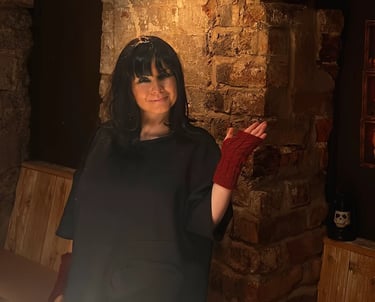 woman at Traitors event wearing a wig and red fingerless gloves.
