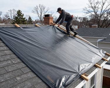 Technician carefully removing soot from a home's interior wall after a fire.
