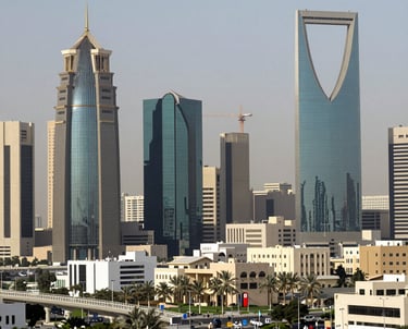 SteelNexus engineers reviewing detailed shop drawings on site with a backdrop of a large industrial steel structure under construction.