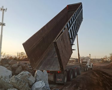 aggregate delivery truck supplying materials to active construction site