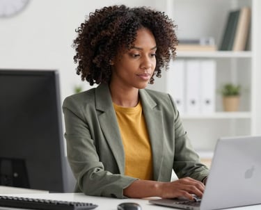 Photo of a friendly bookkeeper at a desk with financial documents and a laptop, focused on organizing records.