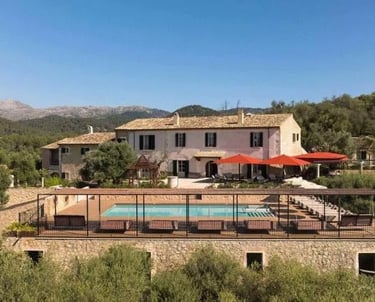 Swimming Pool with Sun Loungers and Red Parasols at Son Sabater by Zafiro