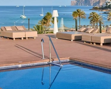 Rooftop Swimming Pool, Sun Loungers and Palm Trees Overlooking the Coast at Zafiro Rey Don Jaime