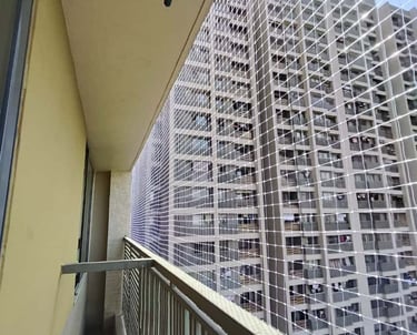 Wide shot of a residential balcony fully secured with sturdy pigeon nets.