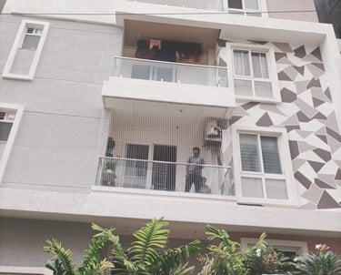 Photo of a balcony in Besant Nagar fitted with sturdy anti-pigeon nets.