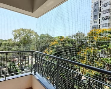 A close-up of a securely installed balcony safety net on a residential building in Perungudi.