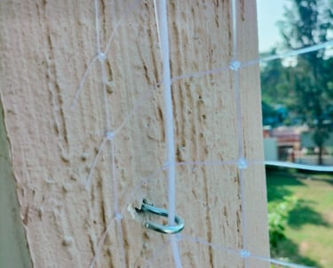 Technician carefully installing strong safety net on an apartment balcony in Sholinganallur.