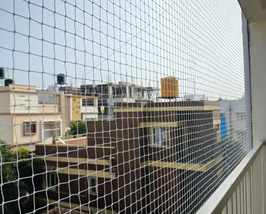 Technician carefully measuring a balcony for a custom safety net installation.