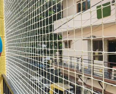 Close-up of a sturdy balcony safety net securely installed on a residential balcony in Whitefield.